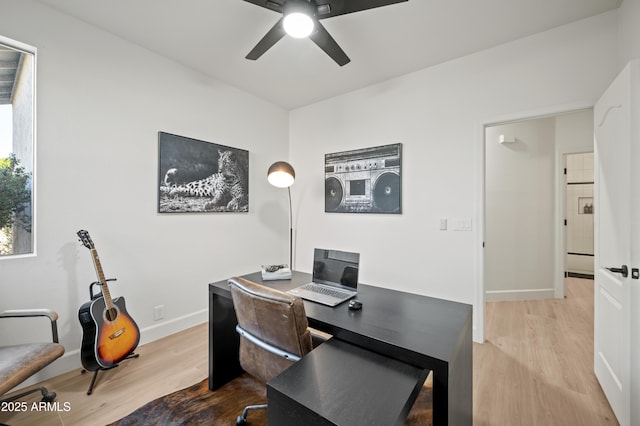 office space with baseboards, a ceiling fan, and wood finished floors