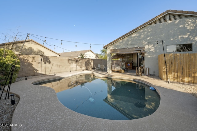 view of swimming pool with a patio area, a fenced backyard, and a fenced in pool