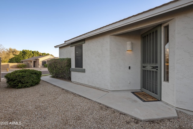 property entrance featuring stucco siding