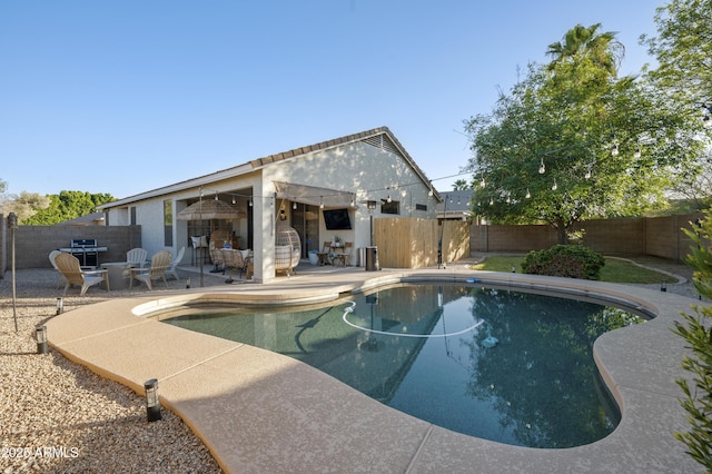 view of pool featuring a patio area, a fenced in pool, and a fenced backyard