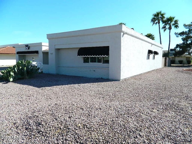 view of side of property featuring stucco siding