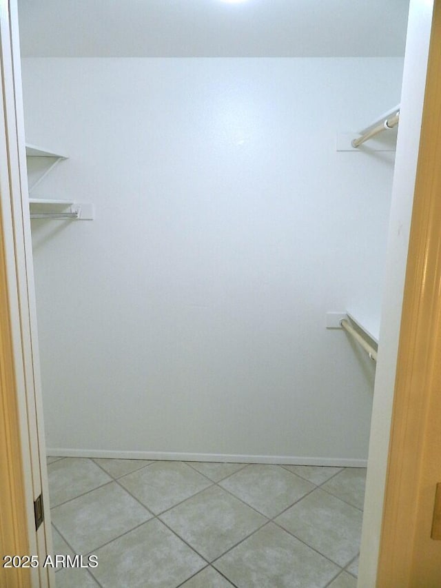 walk in closet featuring tile patterned flooring