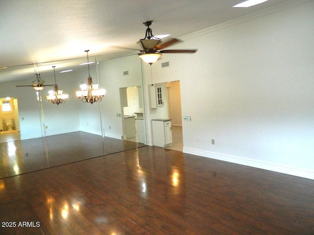 interior space with wood finished floors, visible vents, ornamental molding, baseboards, and ceiling fan with notable chandelier