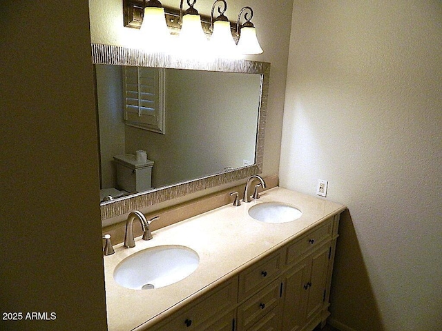 full bathroom featuring a sink and double vanity