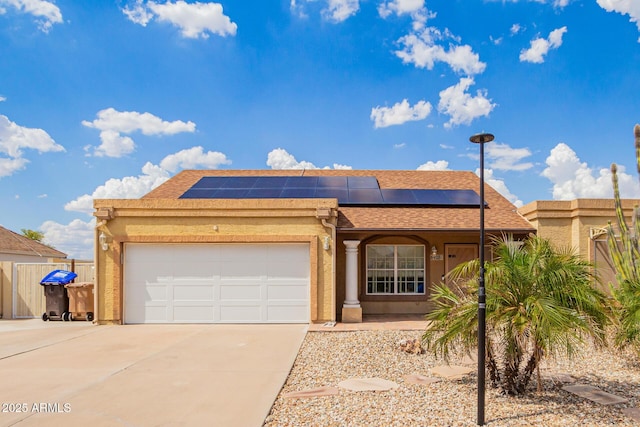 6908 W Sunnyside Dr, Peoria, AZ 85345 - view of front of home featuring concrete driveway, roof mounted solar panels, a garage, and stucco siding
