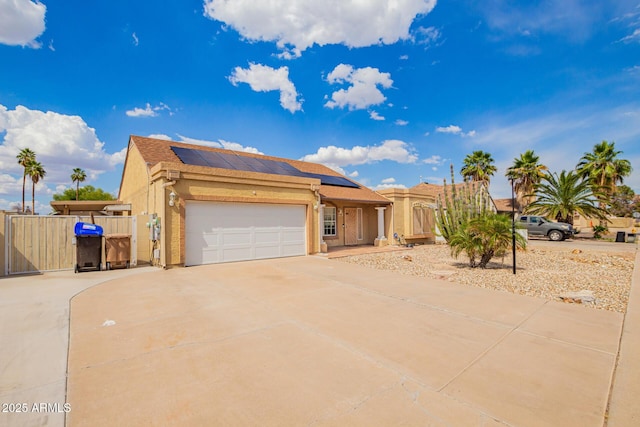 6908 W Sunnyside Dr, Peoria, AZ 85345 - view of front of home with driveway, stucco siding, solar panels, a gate, and a garage