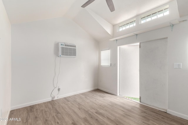 6908 W Sunnyside Dr, Peoria, AZ 85345 - unfurnished room featuring a wall mounted air conditioner, wood finished floors, ceiling fan, lofted ceiling, and baseboards