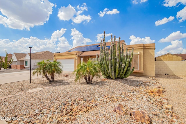 6908 W Sunnyside Dr, Peoria, AZ 85345 - view of front of property with a garage, stucco siding, roof mounted solar panels, fence, and a residential view