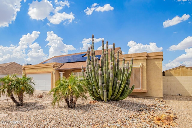 6908 W Sunnyside Dr, Peoria, AZ 85345 - view of front of house with an attached garage, stucco siding, solar panels, and fence