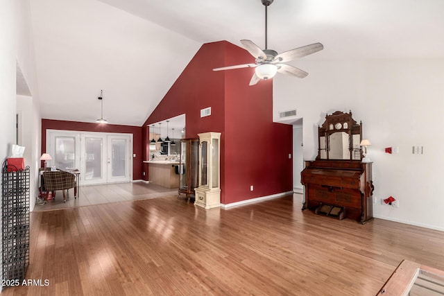 6908 W Sunnyside Dr, Peoria, AZ 85345 - living area with high vaulted ceiling, a ceiling fan, light wood finished floors, and baseboards