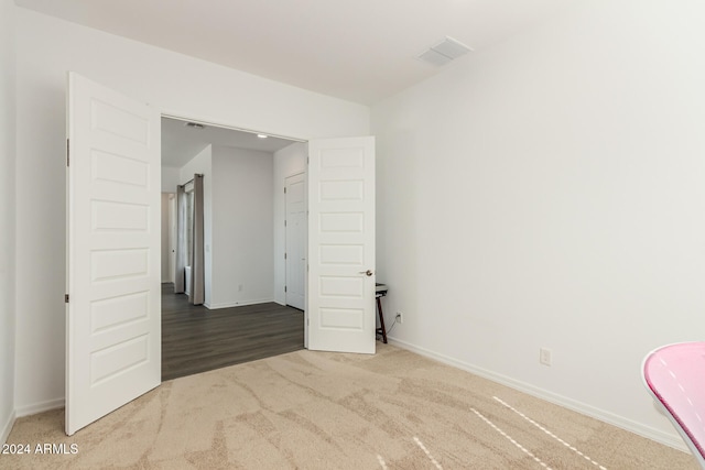 spare room featuring wood-type flooring