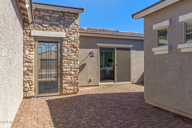 entrance to property featuring a patio