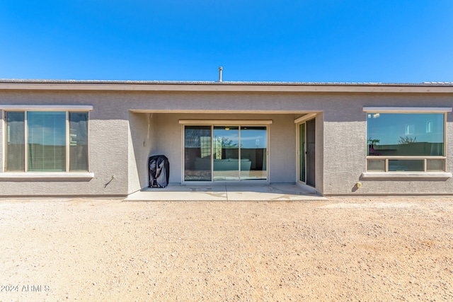 back of house with a patio