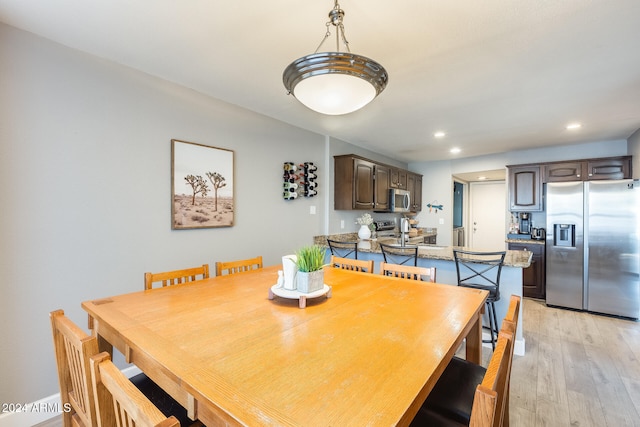 dining area with light hardwood / wood-style floors