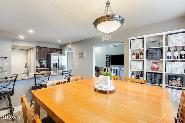 dining area with sink and light hardwood / wood-style flooring