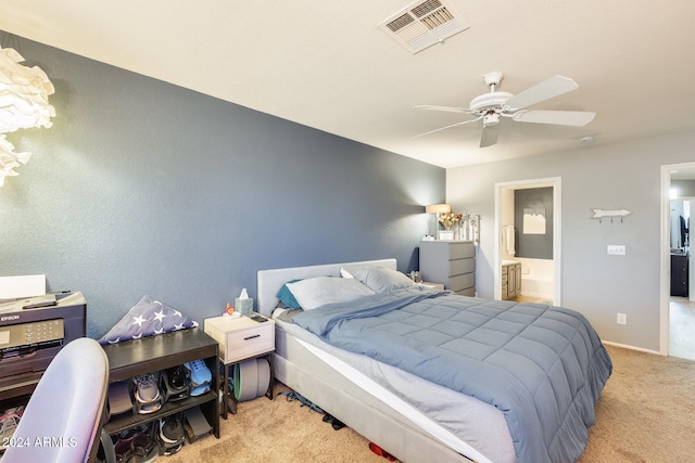 carpeted bedroom featuring ensuite bath and ceiling fan