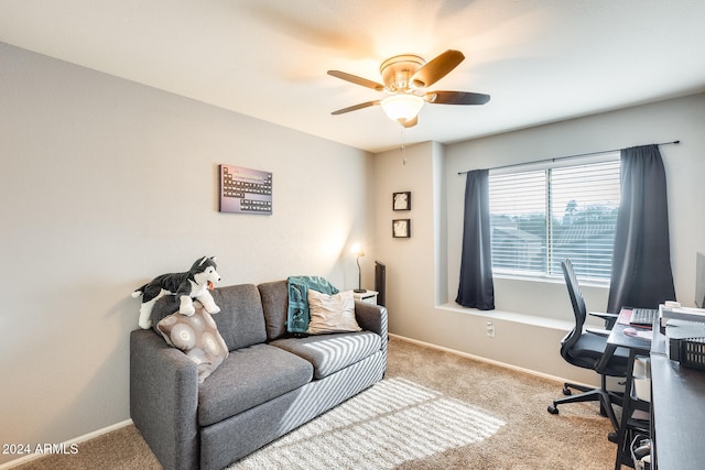 carpeted office space featuring ceiling fan