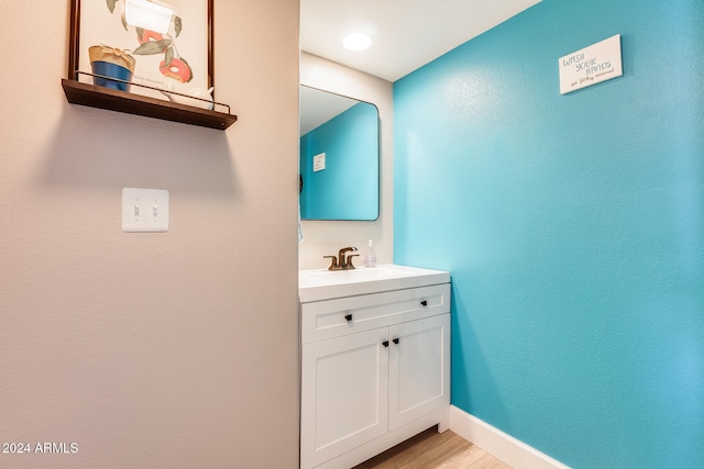 bathroom featuring hardwood / wood-style floors and vanity