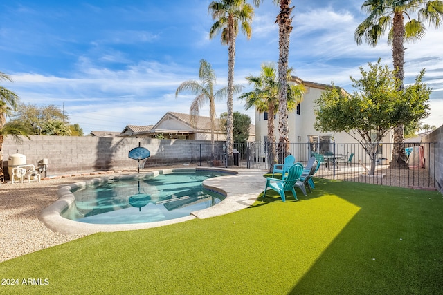 view of swimming pool featuring a yard