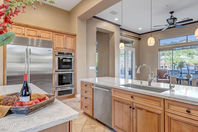 42023 N Bridlewood Way, Anthem, AZ 85086 - kitchen with appliances with stainless steel finishes, a sink, ceiling fan, light stone counters, and decorative light fixtures