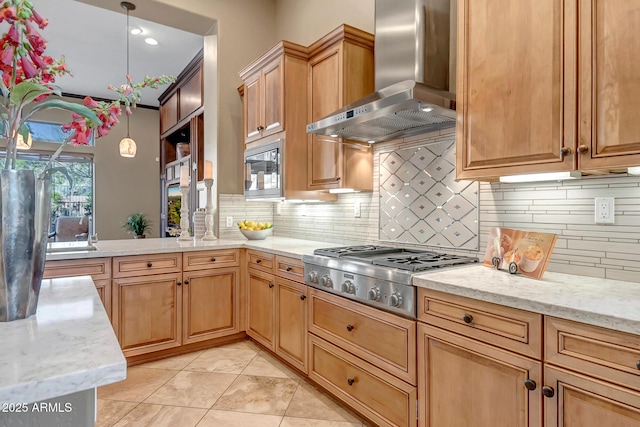 42023 N Bridlewood Way, Anthem, AZ 85086 - kitchen featuring wall chimney range hood, stainless steel appliances, tasteful backsplash, and hanging light fixtures