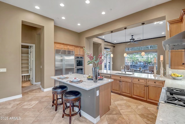42023 N Bridlewood Way, Anthem, AZ 85086 - kitchen with appliances with stainless steel finishes, a sink, recessed lighting, a peninsula, and a center island