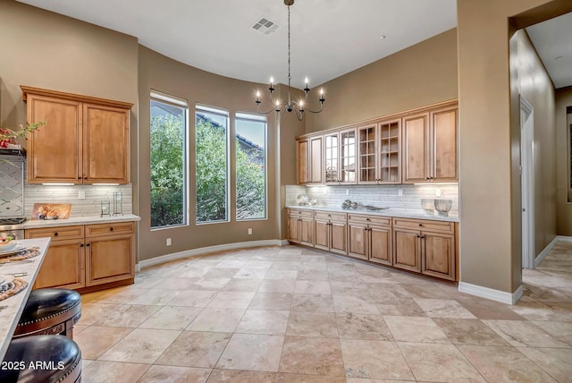 42023 N Bridlewood Way, Anthem, AZ 85086 - kitchen featuring backsplash, light countertops, and a chandelier