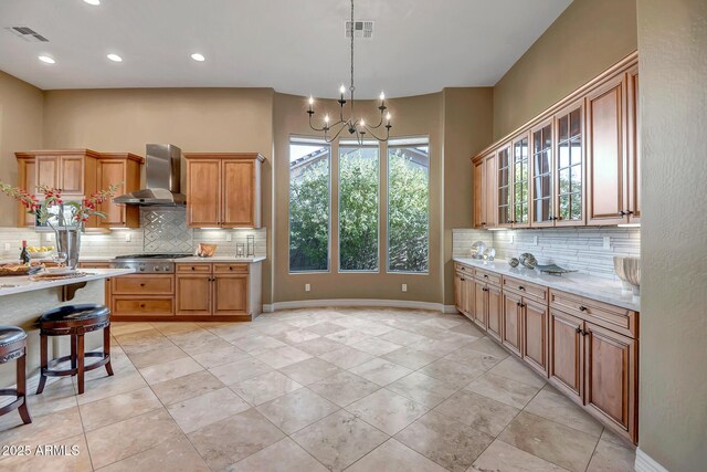 42023 N Bridlewood Way, Anthem, AZ 85086 - kitchen with wall chimney exhaust hood, tasteful backsplash, a chandelier, recessed lighting, and hanging light fixtures