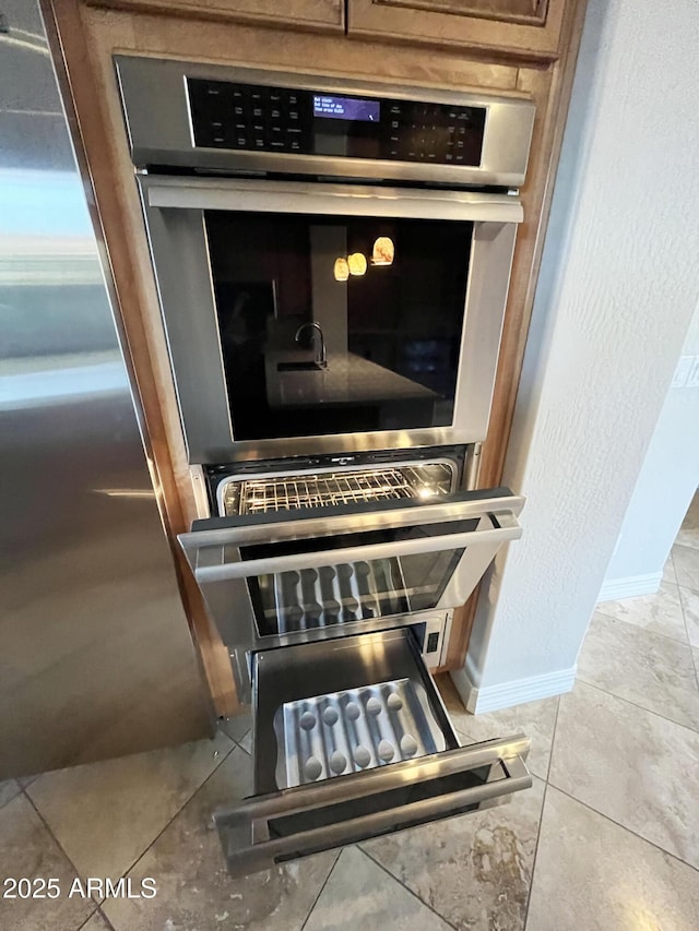 42023 N Bridlewood Way, Anthem, AZ 85086 - kitchen view of baseboards and stainless steel double oven