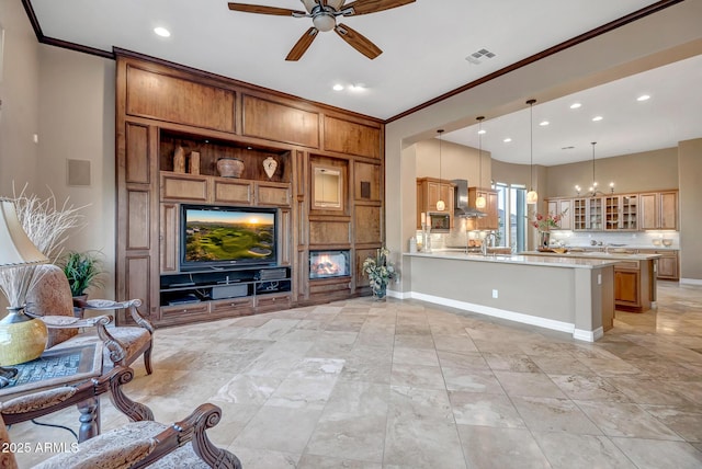 42023 N Bridlewood Way, Anthem, AZ 85086 - living area featuring ceiling fan, ornamental molding, recessed lighting, baseboards, and a chandelier