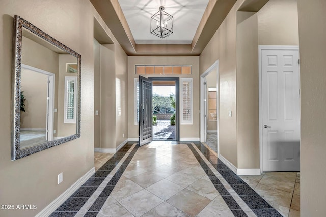 42023 N Bridlewood Way, Anthem, AZ 85086 - foyer featuring inlaid floor details, baseboards, and a chandelier