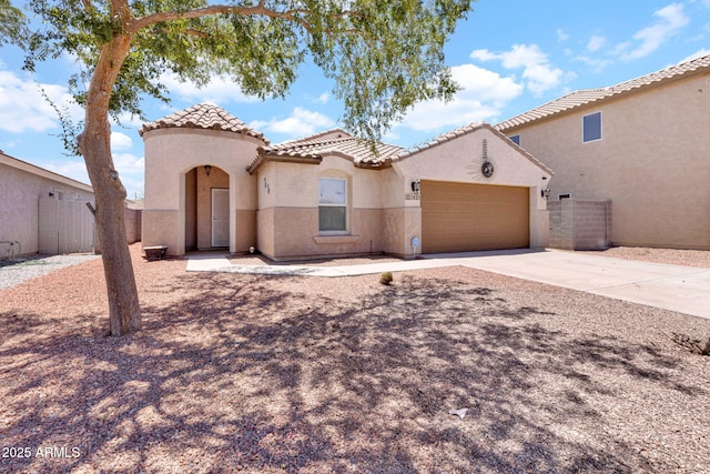 1623 E Maplewood Ave, Buckeye, AZ 85326 - mediterranean / spanish house featuring a garage, concrete driveway, a tiled roof, and stucco siding