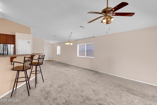 1623 E Maplewood Ave, Buckeye, AZ 85326 - living room with lofted ceiling, light carpet, and a ceiling fan