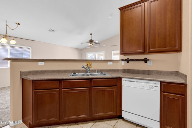 1623 E Maplewood Ave, Buckeye, AZ 85326 - kitchen featuring dishwasher, a ceiling fan, vaulted ceiling, light tile patterned flooring, and brown cabinetry