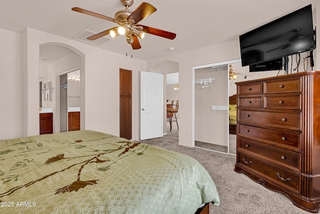 1623 E Maplewood Ave, Buckeye, AZ 85326 - bedroom with arched walkways, carpet flooring, a closet, a ceiling fan, and connected bathroom
