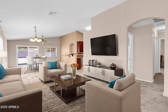 1623 E Maplewood Ave, Buckeye, AZ 85326 - living area with arched walkways, a chandelier, vaulted ceiling, and light carpet