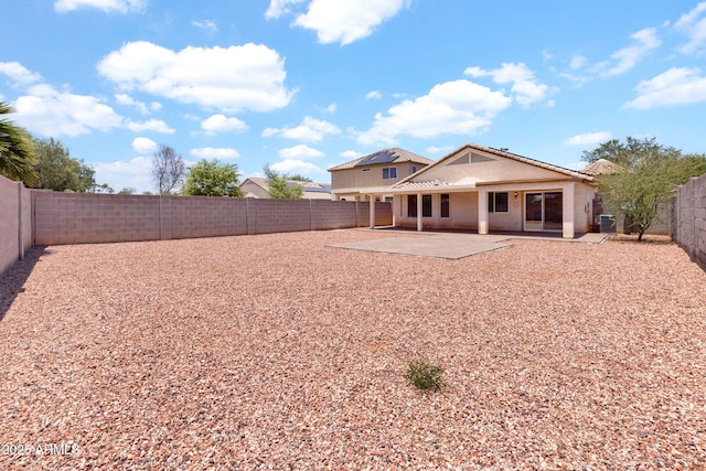 1623 E Maplewood Ave, Buckeye, AZ 85326 - back of house featuring stucco siding, a patio area, and a fenced backyard