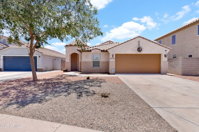 1623 E Maplewood Ave, Buckeye, AZ 85326 - mediterranean / spanish house with an attached garage, concrete driveway, stucco siding, and a tiled roof