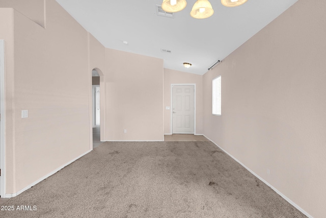 1623 E Maplewood Ave, Buckeye, AZ 85326 - unfurnished room featuring arched walkways, carpet, and vaulted ceiling