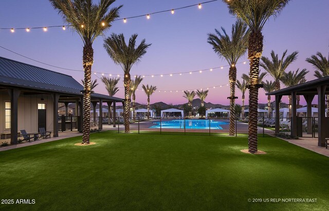 1956 W Rowel Rd, Phoenix, AZ 85085 - yard at dusk featuring fence, a patio, and a community pool