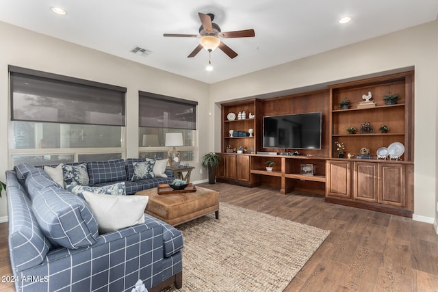 living room with ceiling fan and dark hardwood / wood-style flooring