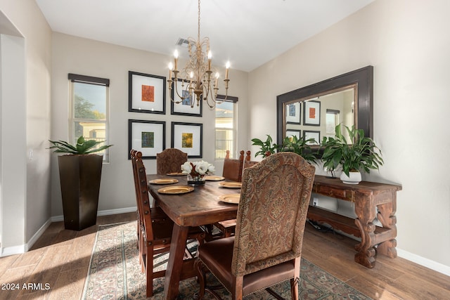 dining space with an inviting chandelier and hardwood / wood-style flooring