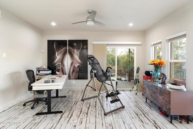 exercise area with light wood-type flooring and ceiling fan