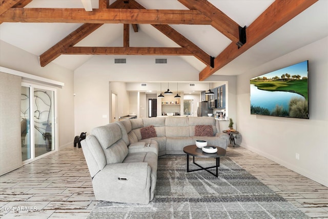 living room with beamed ceiling and high vaulted ceiling