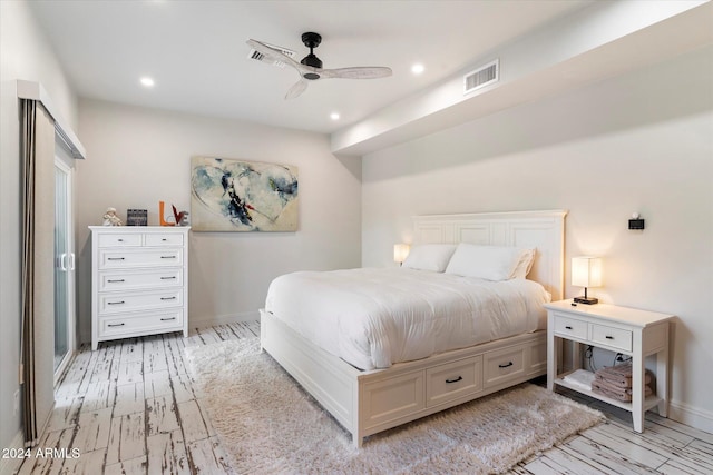 bedroom with ceiling fan and light wood-type flooring