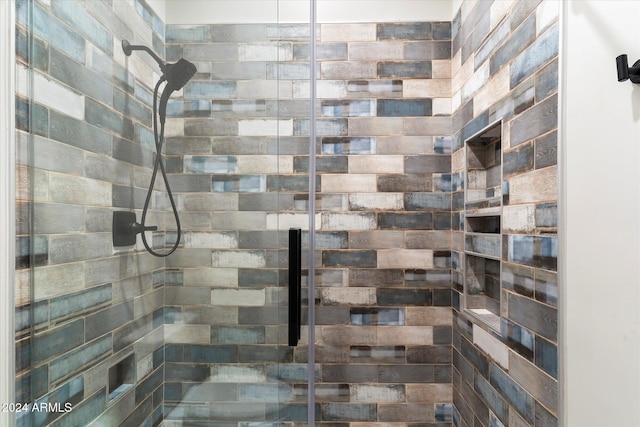 bathroom with tiled shower