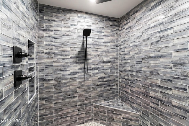 bathroom with tiled shower