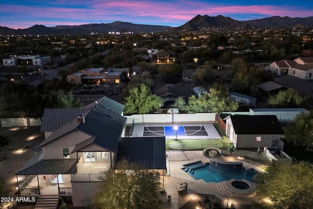 aerial view at dusk featuring a mountain view