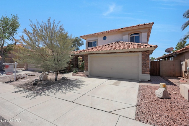7535 W Kimberly Way, Glendale, AZ 85308 - mediterranean / spanish-style home featuring a tiled roof, driveway, stucco siding, and an attached garage