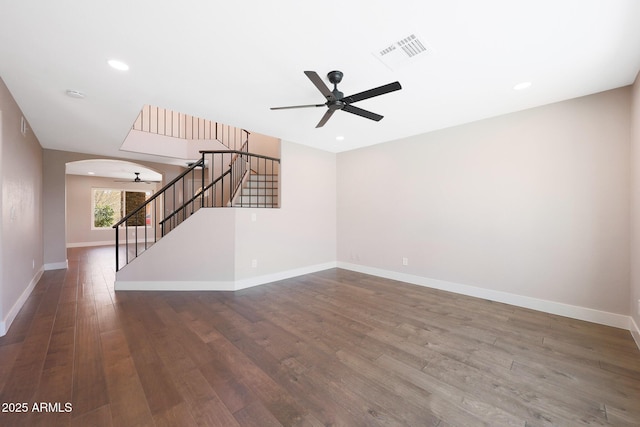 7535 W Kimberly Way, Glendale, AZ 85308 - unfurnished living room with a ceiling fan, stairs, wood finished floors, arched walkways, and recessed lighting